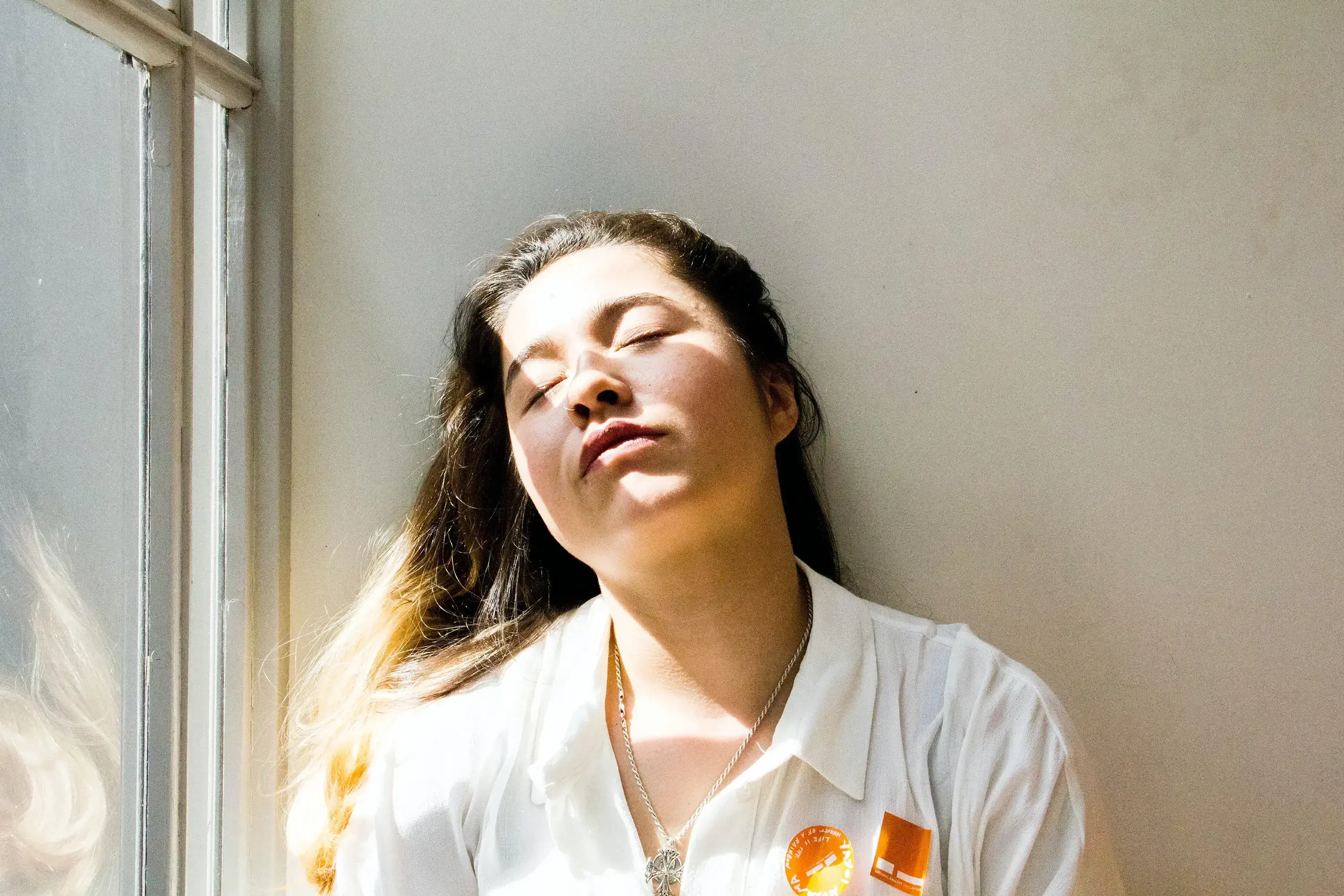 a woman in sunlight with her eyes closed